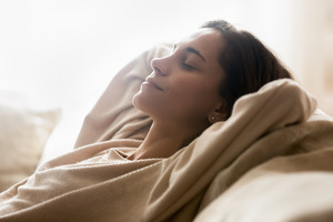 Woman resting at home after a full mouth reconstruction