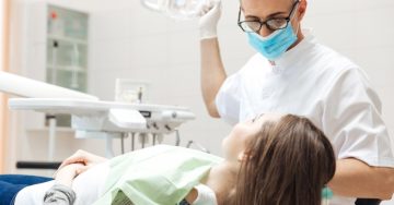 a dentist examining a female patient