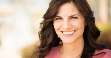 Woman smiling after visiting in-network dentist in McKinney