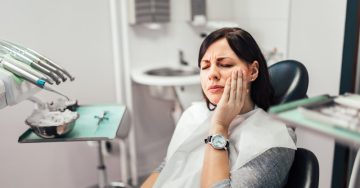 Woman at her dentist with facial pain
