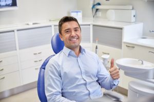 Man smiling after getting urgent dental care