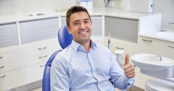 Man smiling after getting urgent dental care
