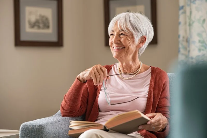 older woman smiling while at home