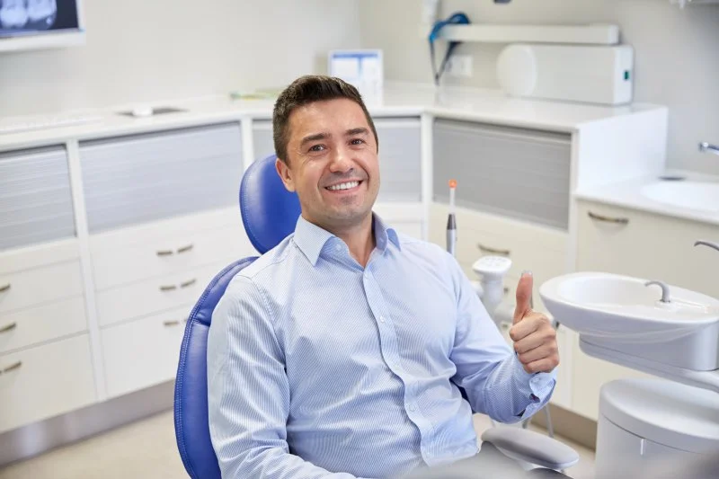 Man smiling after getting urgent dental care